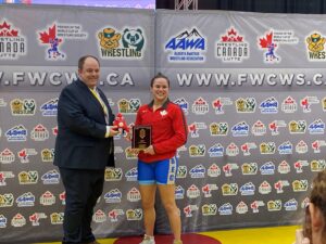Picture of Chariot Safety Officer awarding Female Athlete an award at 2024 Canada Wrestling Olympic Trials